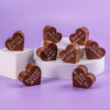 Bagstock & Bumble’s playful pregnancy chocolates, featuring heart-shaped Fairtrade treats with witty lines like 'Too late now!' – ideal for a mum-to-be who loves a laugh.