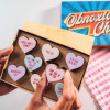 Handsholding Bagstock & Bumble’s Menopause Obnoxious Chocs – cheeky heart-shaped Belgian chocolates with pastel colours and funny slogans. A great gift for friends going through the menopause.