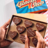 Bagstock & Bumble Sorry Obnoxious Chocs being held up, filled with Belgian chocolate hearts and cheeky slogans, the ideal funny sorry gift.