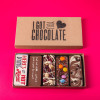 Open ‘I Got You Chocolate’ box featuring five fun-sized handmade chocolate bars with cheeky messages and tasty toppings – a great engagement present with a sense of humour.