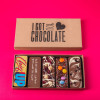 Open ‘I Got You Chocolate’ box showing five handmade chocolate bars with cheeky messages and tasty toppings – a thoughtful and uplifting get well soon gift.