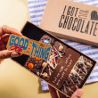 Hand holding a chocolate bar with the message “Good job with the thing” above a selection box – a playful way to say well done with chocolate.