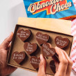 Bagstock & Bumble Obnoxious Chocs gift box packed with heart-shaped Fairtrade Belgian chocolate and sarcastic pregnancy phrases like 'Future MILF', a hilarious gift for mums-to-be.