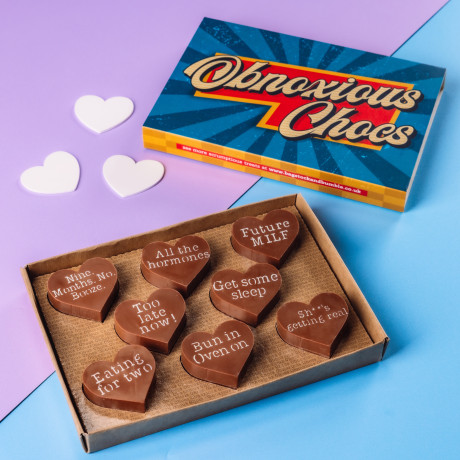 Cheeky assortment of Bagstock & Bumble Fairtrade chocolates engraved with bold pregnancy sayings, a fun and slightly rude baby shower gift with serious chocolate credentials.