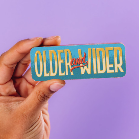 A solid milk chocolate picture bar with the message 'Older and wider'