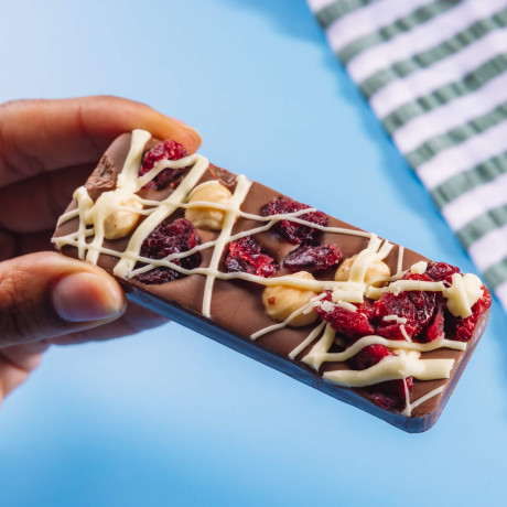 A small but loaded milk chocolate bar with hazelnuts and cranberries then drizzled with white chocolate.