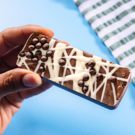 Honeycomb crunch bar made with Belgian milk chocolate plus sprinkles and white chocolate drizzle