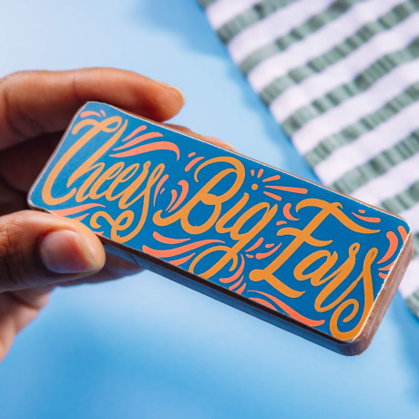 'Cheer big ears' in colourful typography transferred onto a milk chocolate bar.