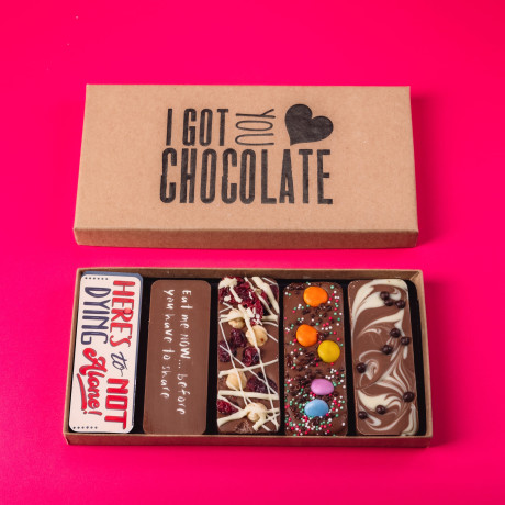 Open ‘I Got You Chocolate’ box featuring five fun-sized handmade chocolate bars with cheeky messages and tasty toppings – a great engagement present with a sense of humour.