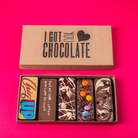 Open ‘I Got You Chocolate’ box showing five handmade chocolate bars with cheeky messages and tasty toppings – a thoughtful and uplifting get well soon gift.